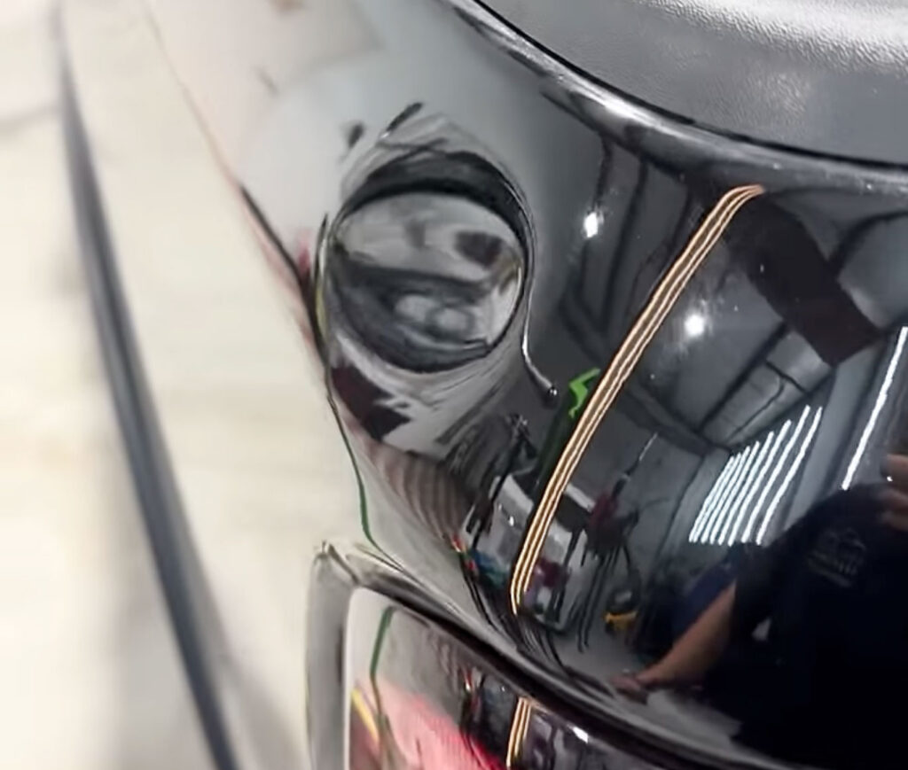 Large dent fixed same day on the back of a truck using pro tools in Houston.