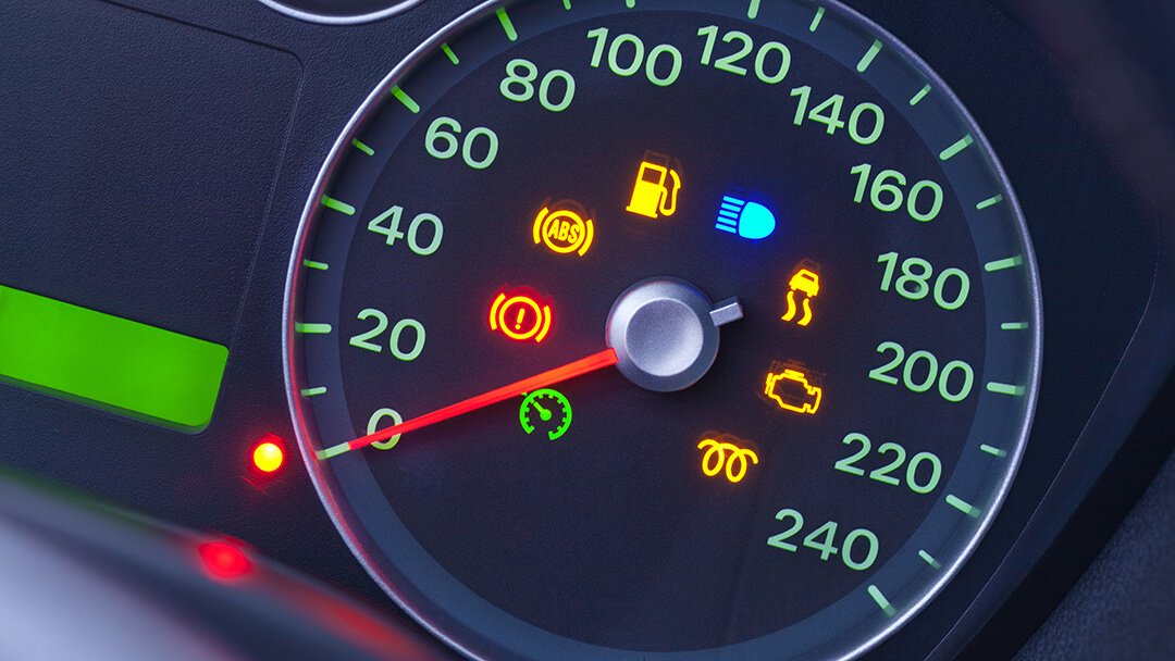Car speedometer with dashboard warning lights lit